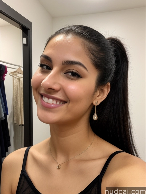 smiling woman in a black top and gold earrings in a closet