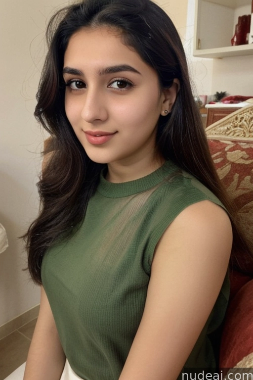 a close up of a woman sitting on a couch wearing a green top