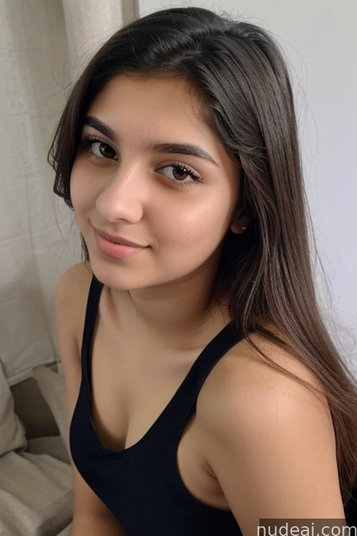 a close up of a woman in a black top sitting on a couch