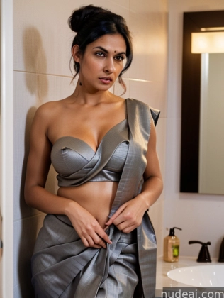 there is a woman in a silver dress standing in a bathroom