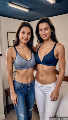 two women in blue and grey bra tops standing next to each other