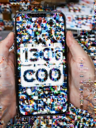 someone holding a cell phone with a mosaic design on it