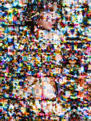 arafed image of a woman in a colorful dress standing in front of a wall of colorful objects