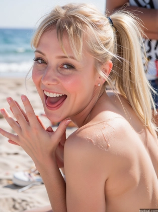 blond woman with a big smile on the beach with her hands on her face