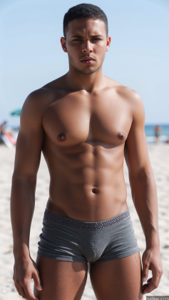 arafed man in a gray underwear standing on a beach